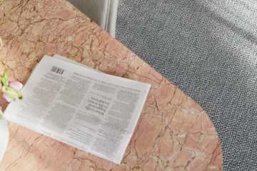 Image depicting quality Bremworth carpet and a coffee table with various items on it, including a newspaper