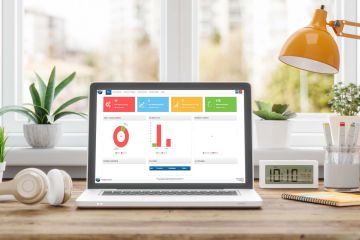 Image of laptop computer on bright and modern desk. The screen shows a report from the Intelligent Workflow module from Frontier Software