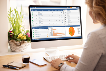 Image depicting a woman viewing the Frontier Software applicant portal, part of the Recruitment Management module, on an apple iMac.