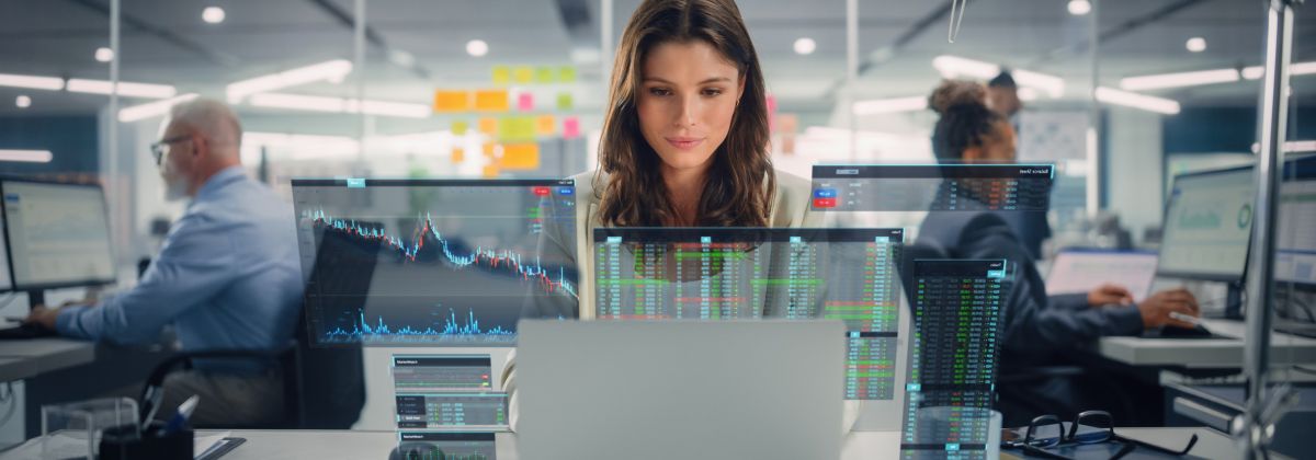 Staff in office with graphs, charts and data overlays.
